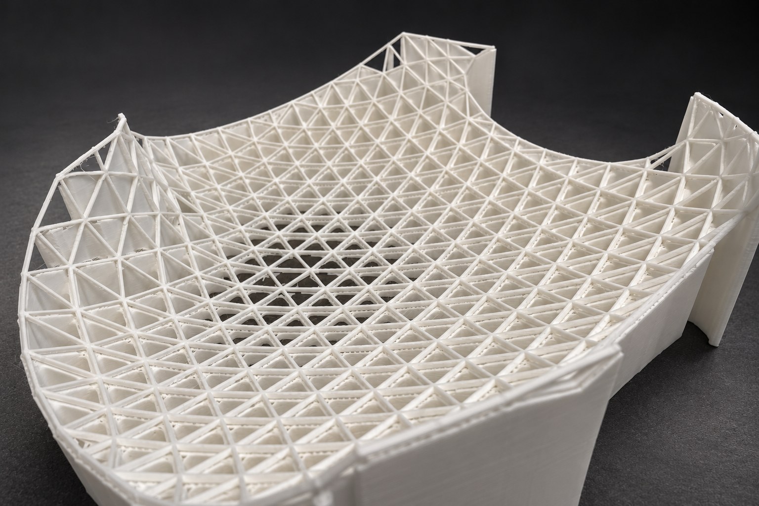 Nir Sivan Architects – 3D-printed model of the REUT Heart gridshell canopy (2025): the lattice shell seen from above, with its print supports