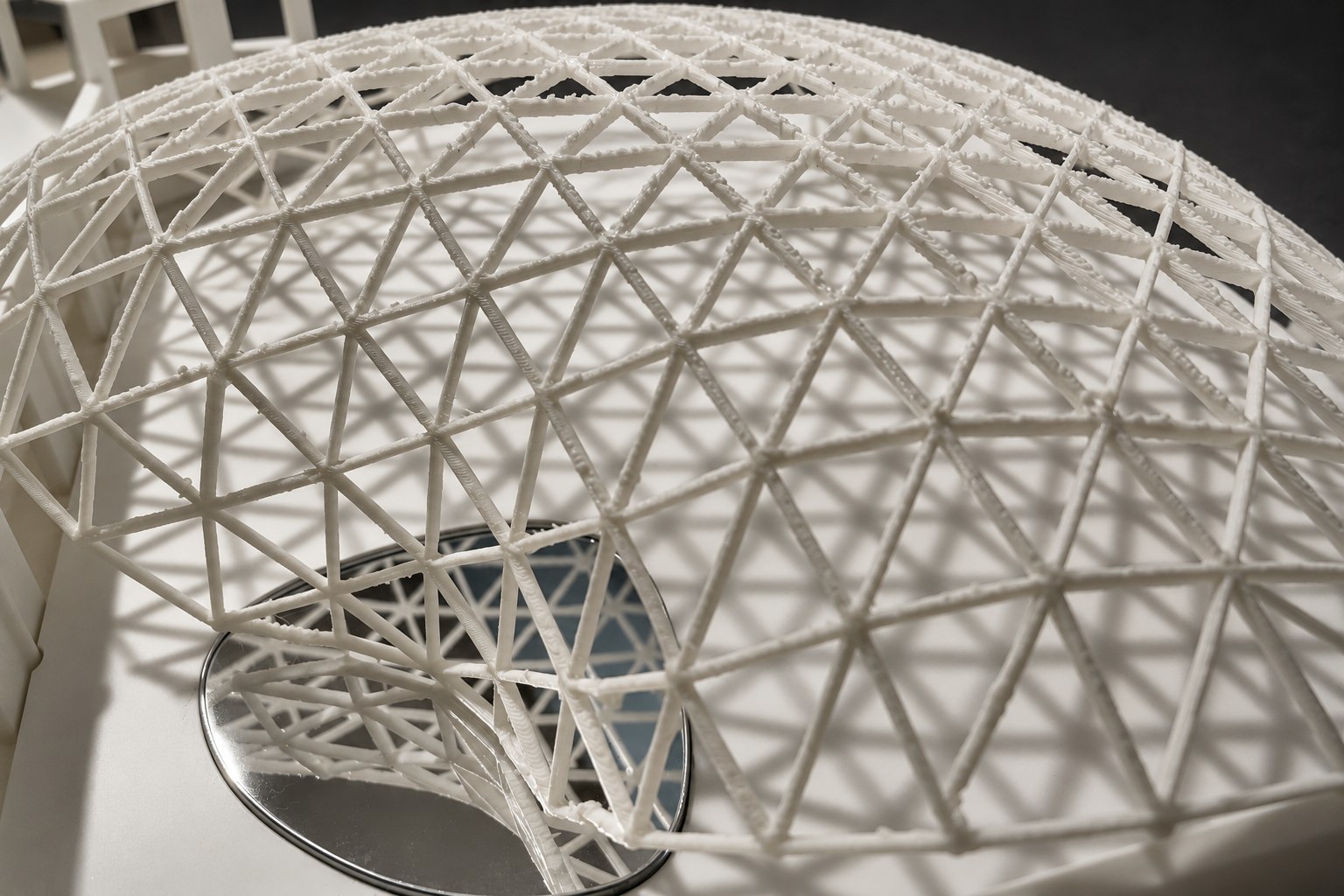 Nir Sivan Architects – 3D-printed model of the REUT Heart gridshell canopy (2025): the lattice over the round mirror of the site model