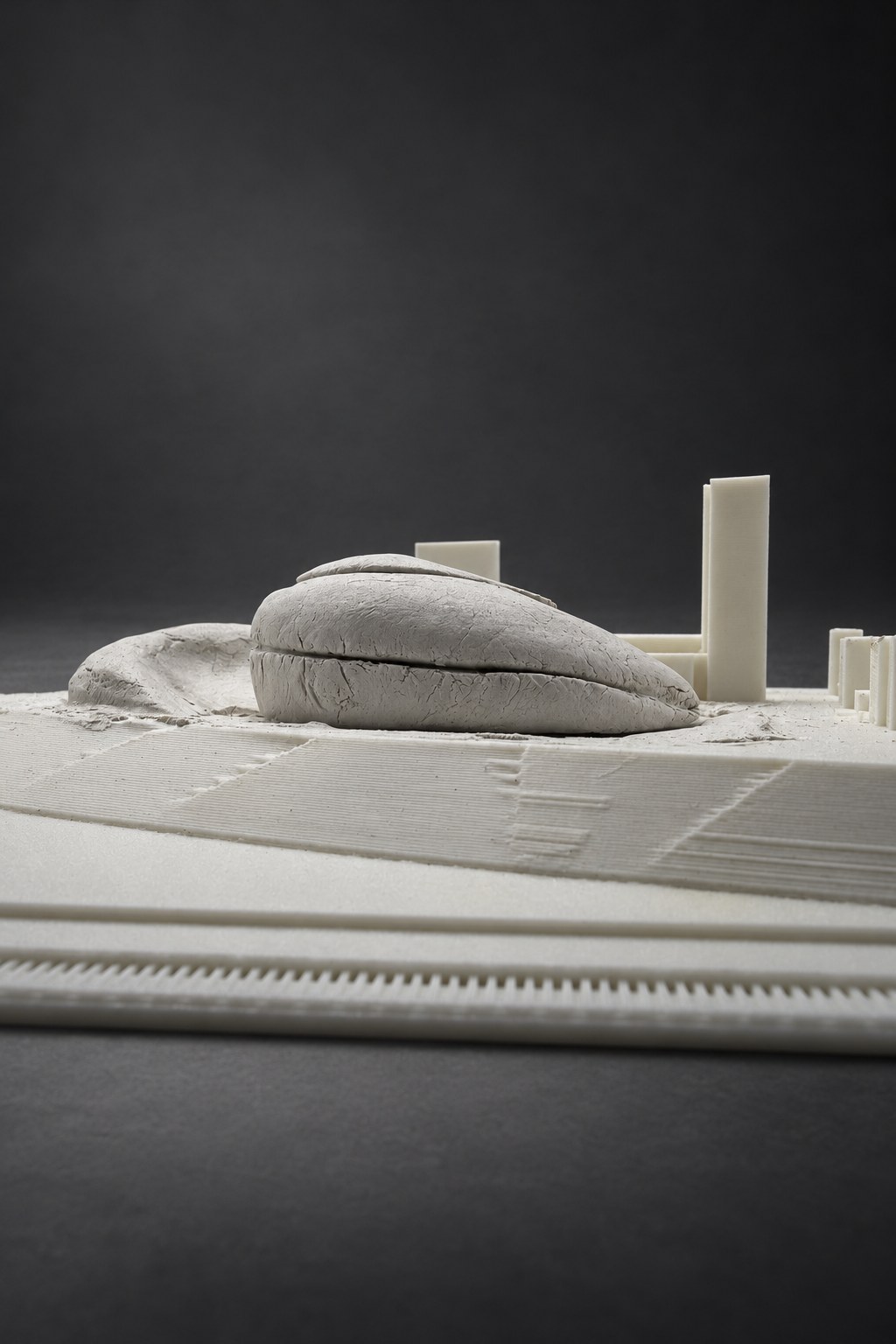 Nir Sivan Architects – Clay study for the Vilnius Congress Centre (2025): the clay study on the site model, seen low
